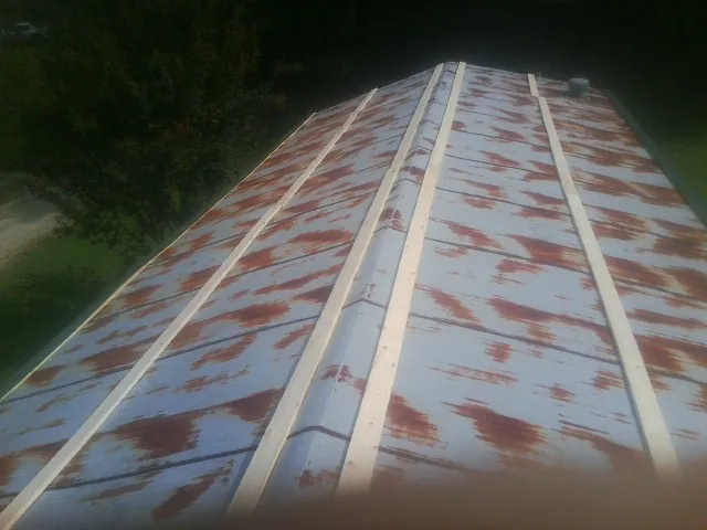 Rusted metal roof panels with new wood purlins before replacement — Storm Damage Roof Repair in Washington Crossing by Roofing Brothers
