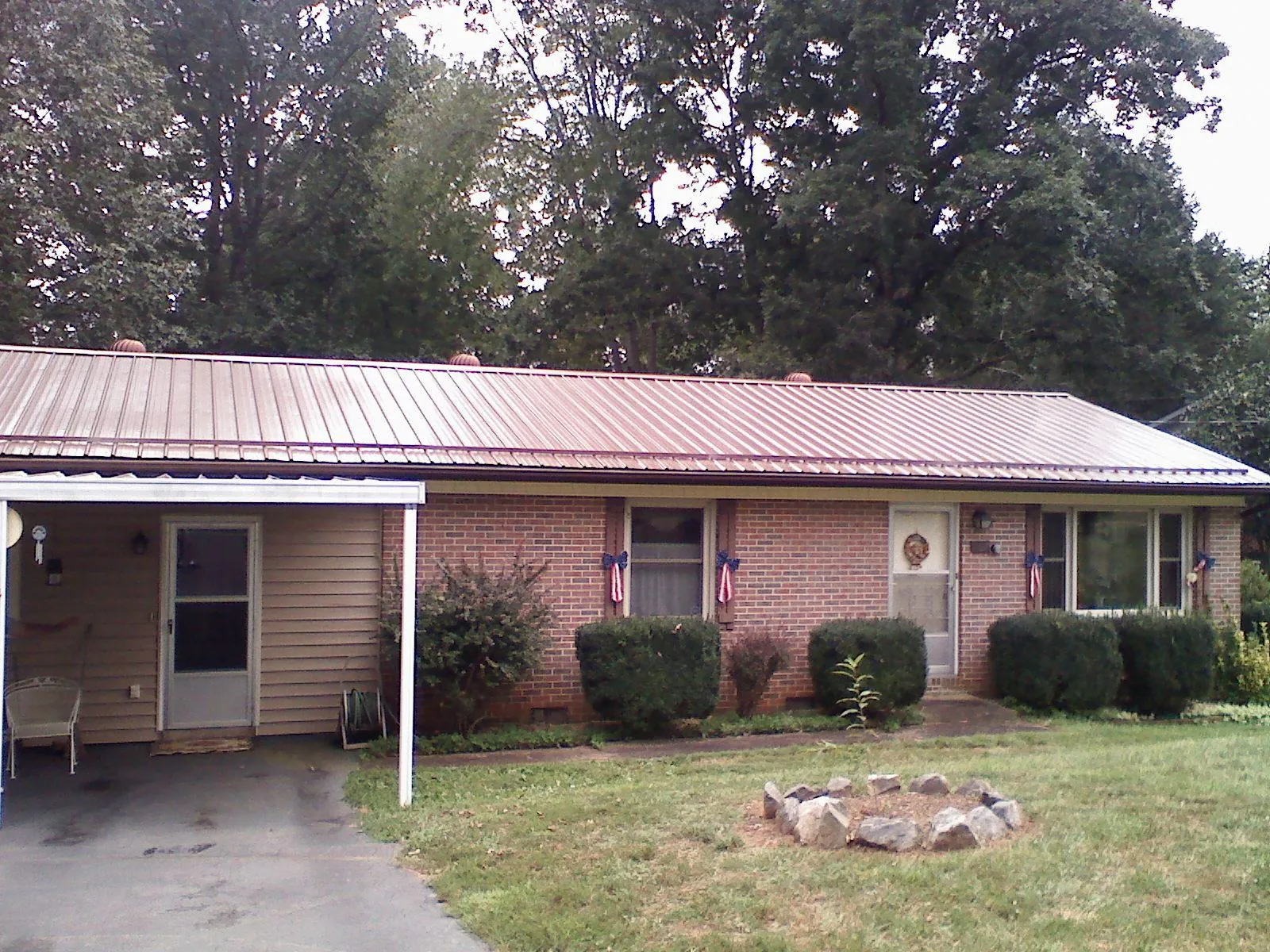 Bronze metal roof and carport on a brick ranch home — Roof Repair work by our crew in Washington Crossing